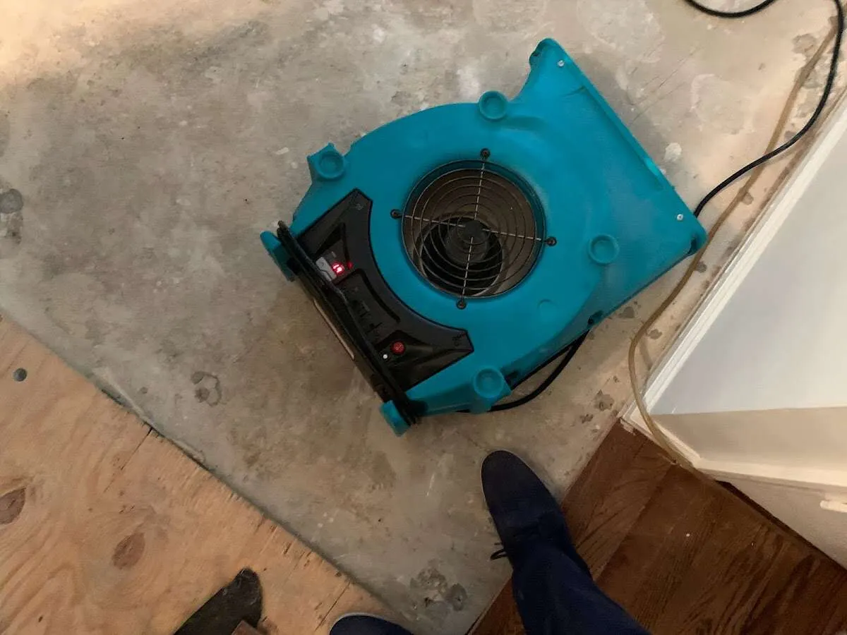 Air mover drying subfloor during Commercial Water Damage Restoration in Little Falls